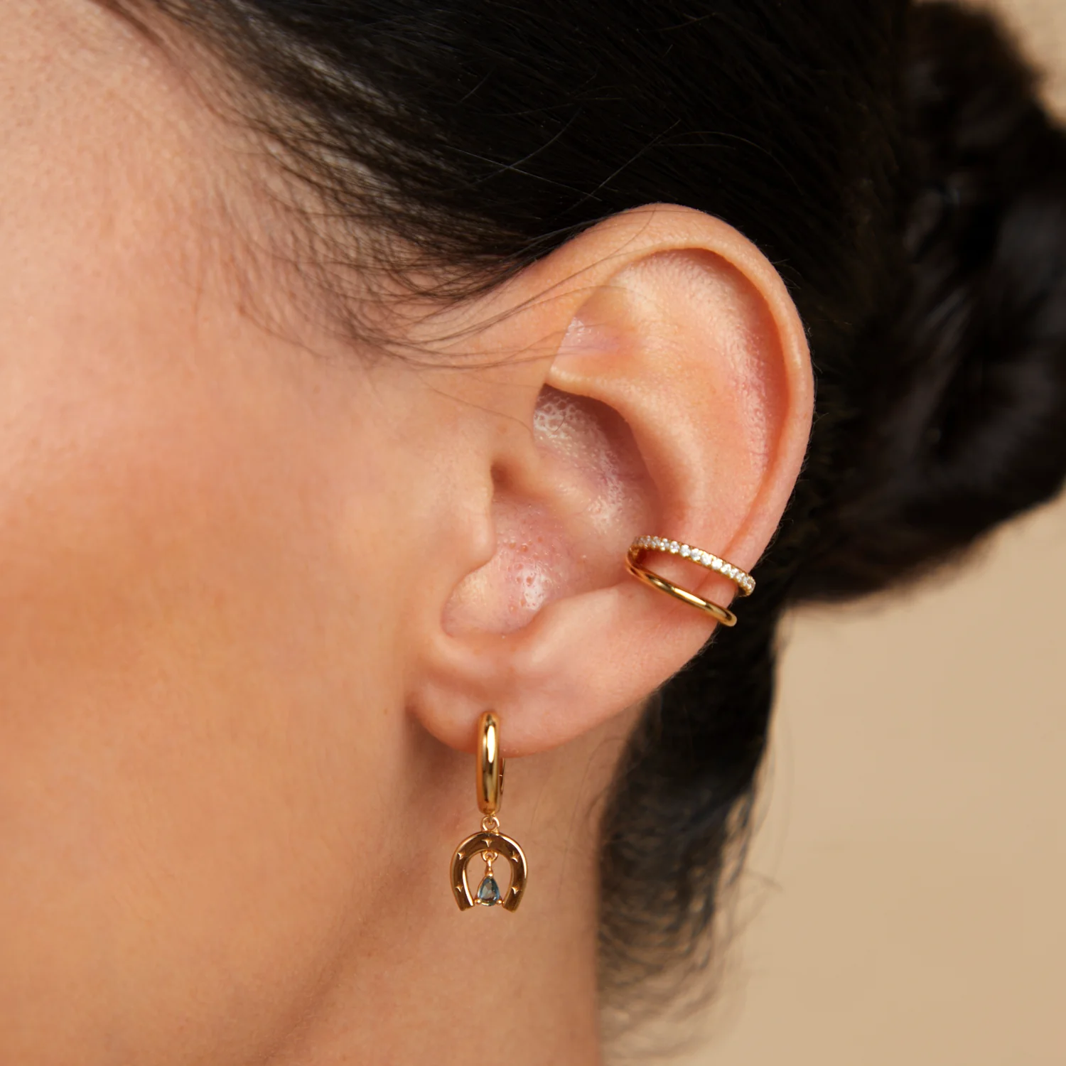 Horseshoe Charm Huggies in Gold - Image 3
